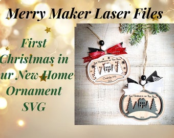 May include: Two laser cut wooden ornaments with a white background. The ornaments are shaped like a house with trees and the text "First Christmas in our New Home" and "Cambridge, MD 2023".