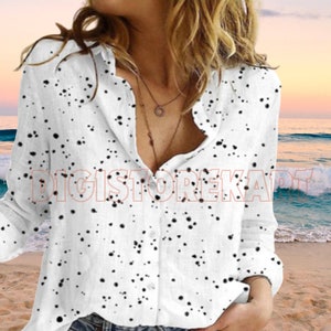 a woman standing on top of a sandy beach