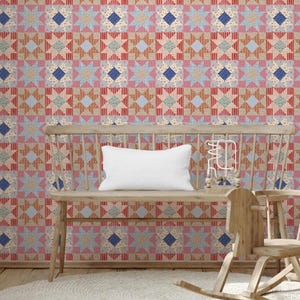 May include: A wooden spindle-back bench with a white rectangular throw pillow and a small wooden bead maze toy. The bench is positioned against a wall covered in wallpaper featuring a repeating geometric star pattern in red, blue, and tan.