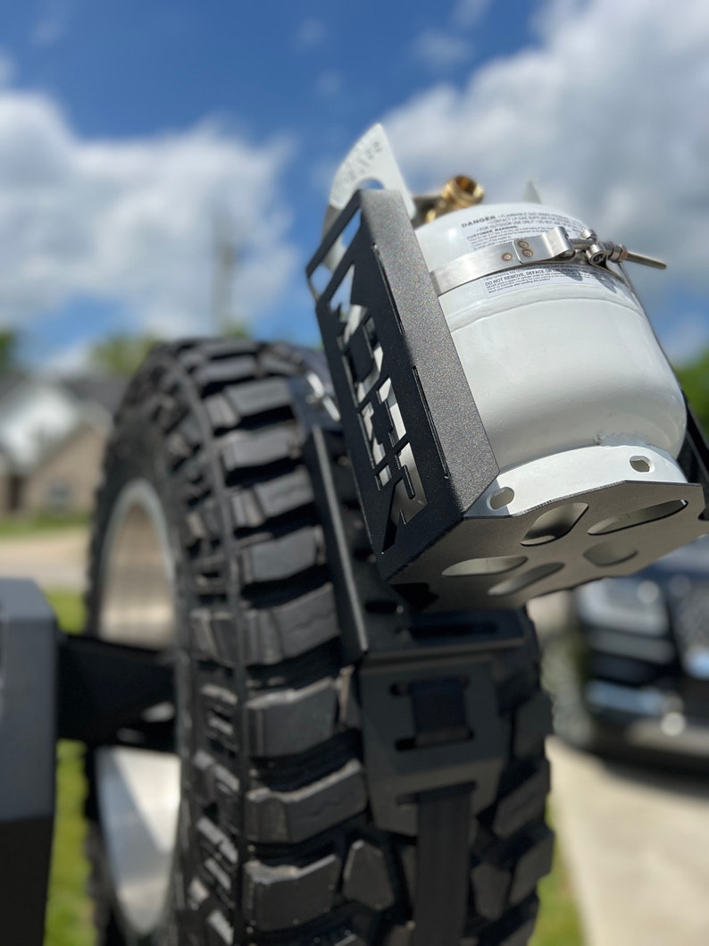 Propane tank mounting bracket and propane tank not included. Shown as an example of mounting options.