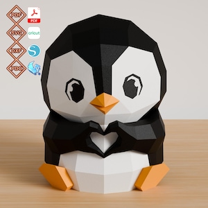 May include: A low-poly papercraft penguin figure with black, white, and orange geometric panels. The penguin has large eyes and is forming a heart shape with its wings. Icons for PDF, SVG, DXF, and PDO file formats are visible on the left.