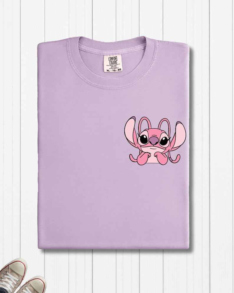 a purple t - shirt with a pink crab on it