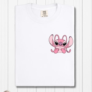 a white t - shirt with a pink octopus on it