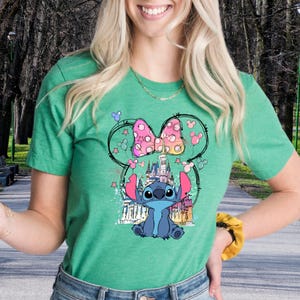 a woman in a green shirt is holding a banana