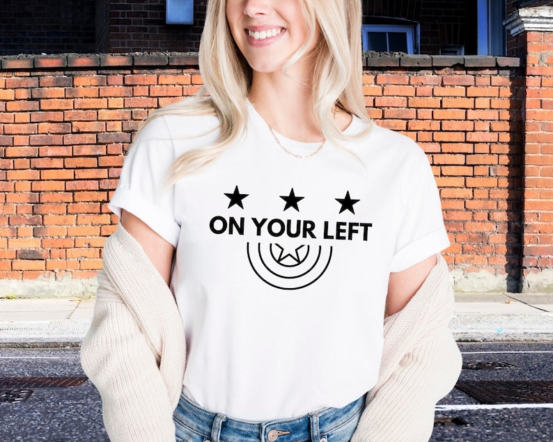 a woman wearing a t - shirt that says on your left