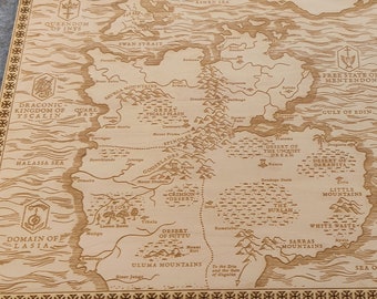 May include: A wooden map of the fictional world of Westeros, featuring the text "The Seven Kingdoms of Westeros" and "Sea of Dorne". The map is engraved with intricate details and a decorative border.