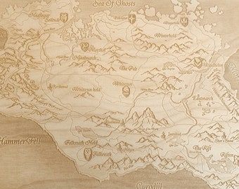 May include: A wooden map of the fictional world of Tamriel from the Elder Scrolls video game series. The map is laser-etched with details of the provinces, cities, and landmarks. The map is surrounded by a decorative border.