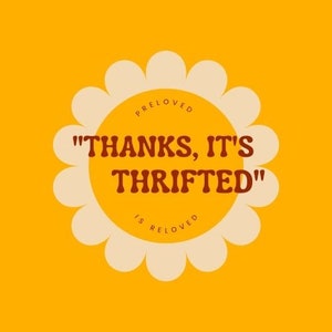 May include: A retro-style graphic on a yellow background. The design features a daisy shape with a yellow center and cream-colored petals. The text "THANKS, IT'S THRIFTED" is in brown, with "PRELOVED" and "IS RELOVED" above and below.