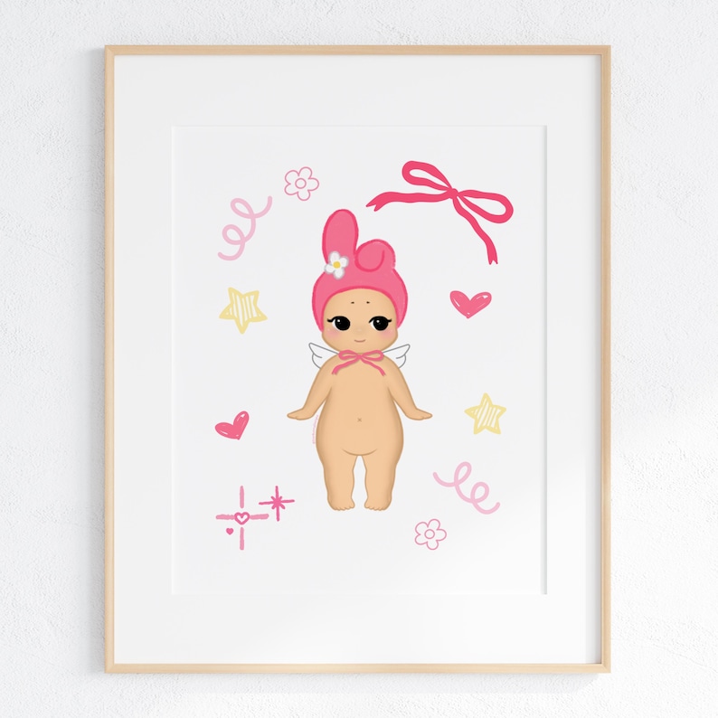 May include: A framed print featuring a whimsical illustration of a cherubic figure. The figure is depicted with a pink bonnet, small wings, and a bow. Pink hearts, stars, and decorative swirls surround the figure, creating a playful and charming aesthetic.