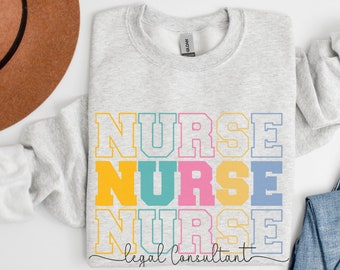 May include: A light gray sweatshirt with the word "NURSE" stacked three times in colorful block letters. The text "legal consultant" is written in a script font below the word "NURSE". A brown hat and blue jeans are also in the image.