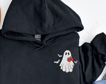 May include: Black hoodie with a white ghost holding a red pumpkin. The ghost is embroidered on the front of the hoodie.