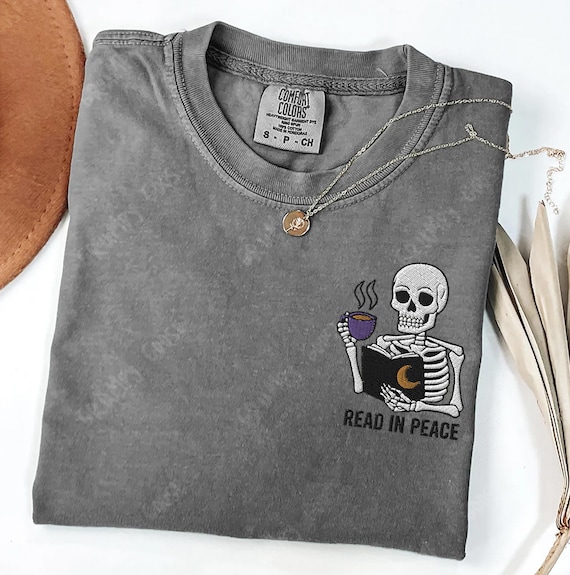 Embroidered Skeleton Book shirt, Read In Peace comfort colors , Gift for book lover, Skull Spooky Season Reading shirt Fantasy Book merch