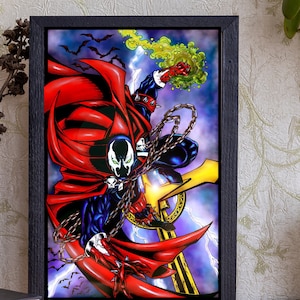May include: A framed illustration of a red and black superhero character with a cape, holding a chain and standing on a cross. The background is a purple and blue sky with lightning bolts and bats.