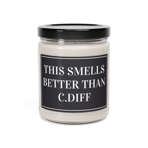 May include: A glass jar candle with a black lid and a black and white label that reads "This smells better than C.Diff".
