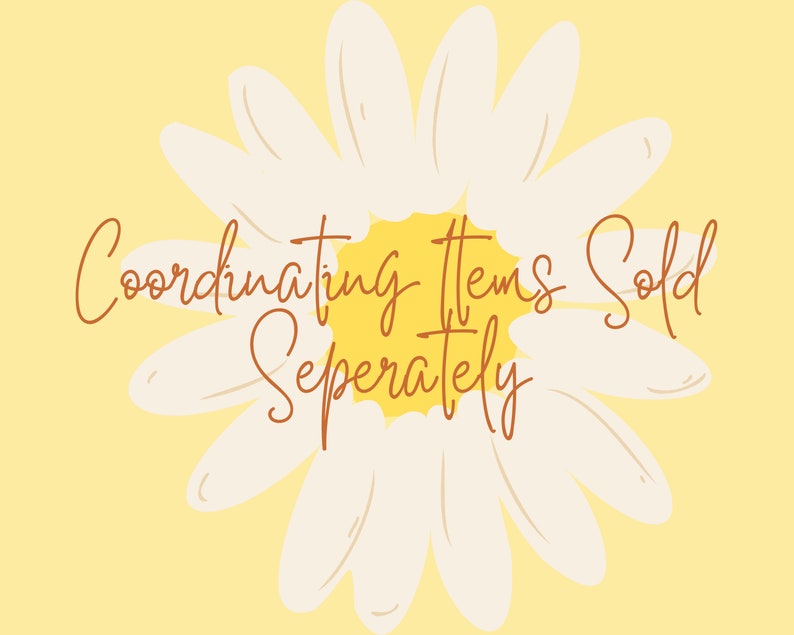 May include: A white daisy with a yellow center on a yellow background. The text "Coordinating Items Sold Separately" is written in brown cursive.