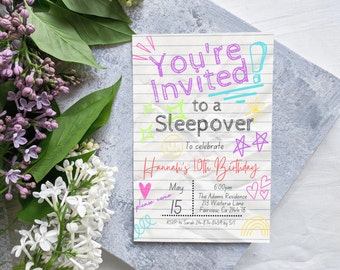 May include: A colorful invitation on lined paper for a sleepover, with the text "You're Invited to a Sleepover" in various colors. The invitation is for Hannah's 10th birthday, with the date, time, and address included. Lilac and white flowers are in the background.