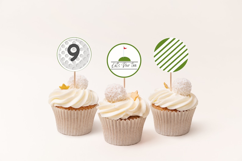 May include: Three white cupcakes with green and white golf-themed cupcake toppers. The toppers say "Let's Par Tee" and feature a golf ball with the number 9 and a golf flag.