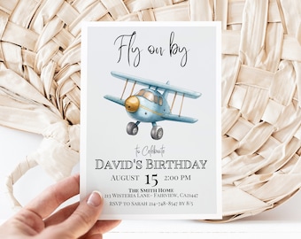 May include: A light blue watercolor airplane illustration on a white invitation card. The card reads "Fly on by" and invites guests to David's birthday on August 15th at 2:00 PM. The card includes the address and RSVP information.