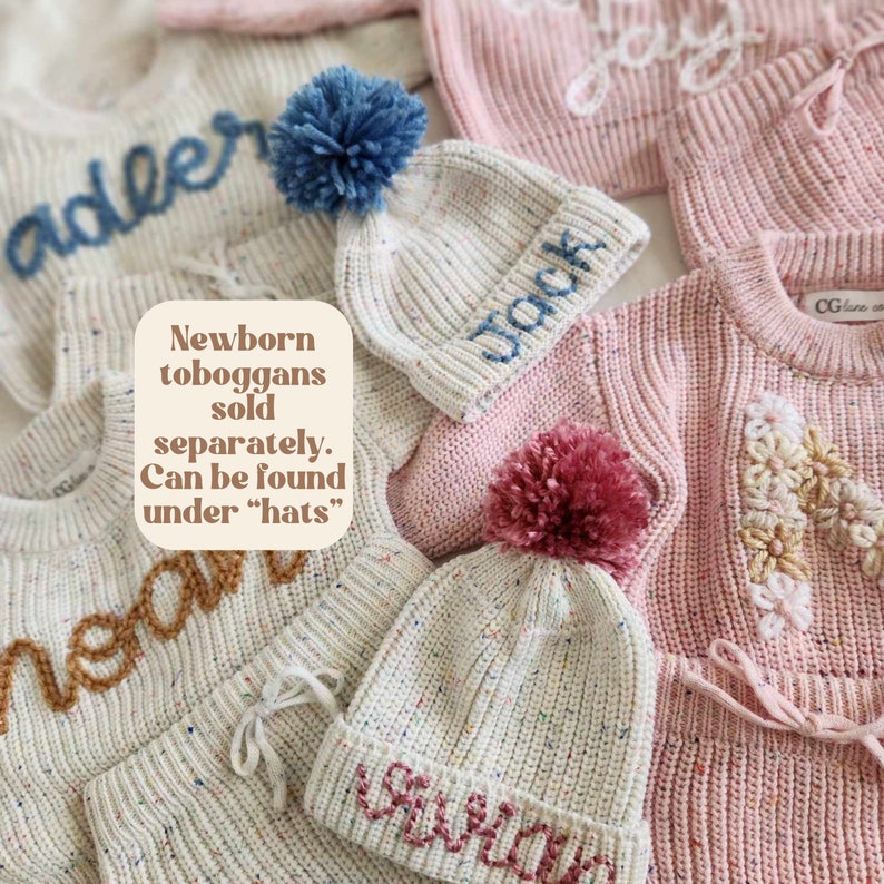 May include: A collection of knit sweaters and beanies featuring speckled cream and pink yarn. The items are embroidered with names like Adler, Jack, Noah, and Vivian. A text box states: Newborn toboggans sold separately. Can be found under hats.