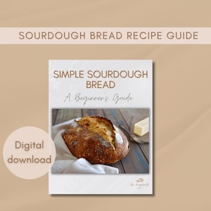 May include: A digital download guide for making sourdough bread. The cover features a close-up of a freshly baked loaf of sourdough bread on a white linen cloth, with a pat of butter on a wooden surface. The title reads "Simple Sourdough Bread: A Beginner's Guide".