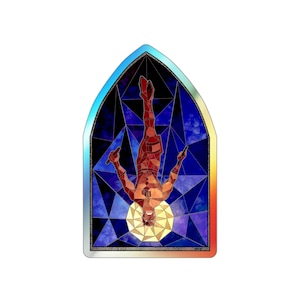May include: A stained glass window design featuring a person in a red and black suit hanging upside down with their arms outstretched. The background is a dark blue with a yellow moon.