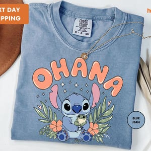 a blue t - shirt with an image of a stitch stitch stitch stitch stitch stitch