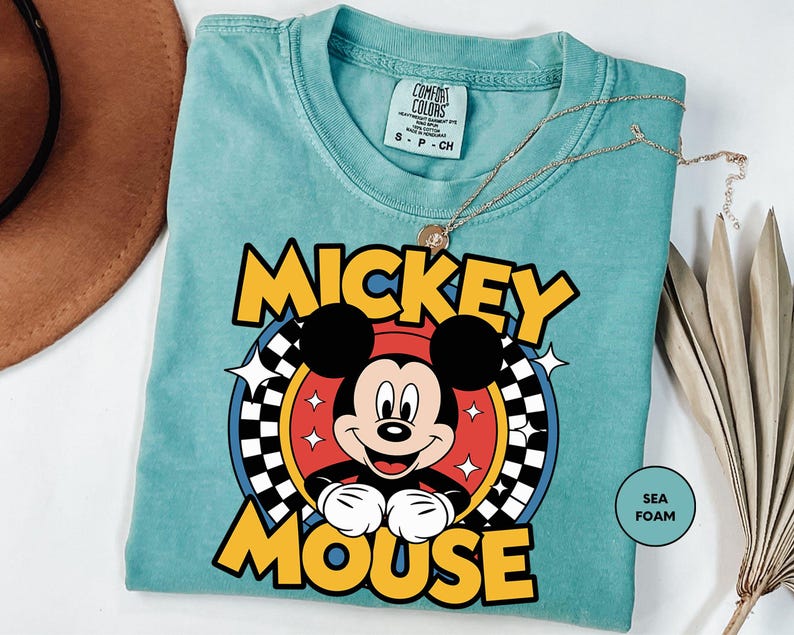 a mickey mouse t - shirt sitting on top of a table