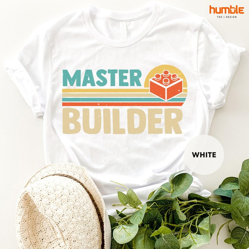 a t - shirt that says master builder next to a hat