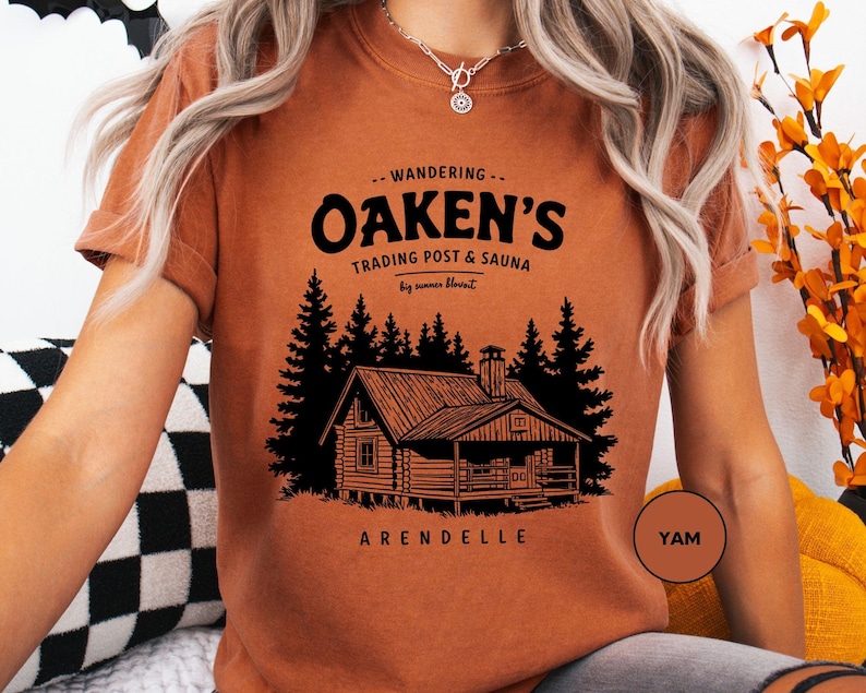 a woman sitting on a couch wearing an orange shirt