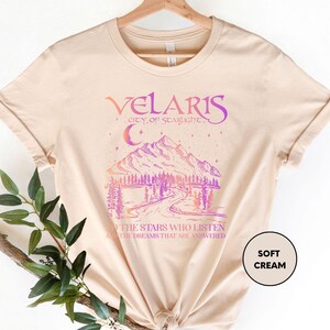 a t - shirt with a picture of a mountain and trees on it