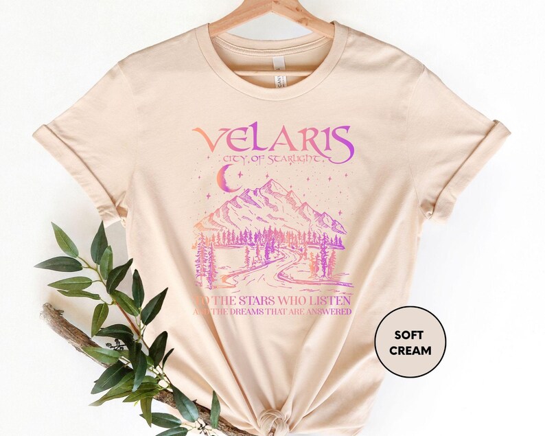 a t - shirt with a picture of a mountain and trees on it