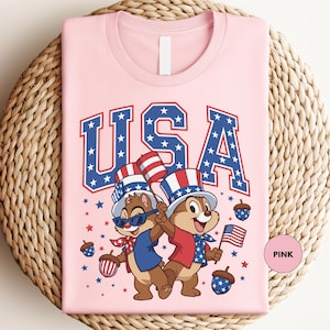 a pink t - shirt with a picture of two bears on it