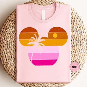 a pink shirt with a palm tree on it