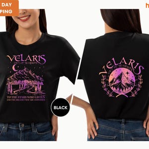a woman wearing a black shirt with a picture of a mountain