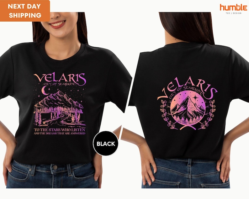 a woman wearing a black shirt with a picture of a mountain