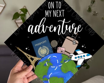 May include: Black graduation cap with the text "On to my next adventure" in white. The cap is decorated with a globe, a passport, a camera, a suitcase, and a plane.