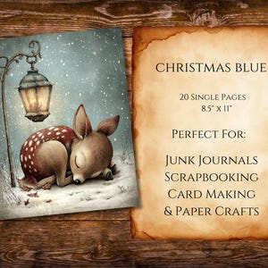 May include: A printed page with the text "CHRISTMAS BLUE" and a winter scene illustration of a sleeping deer under a lamppost. The page is 8.5" x 11" and includes text for junk journals, scrapbooking, card making, and paper crafts.