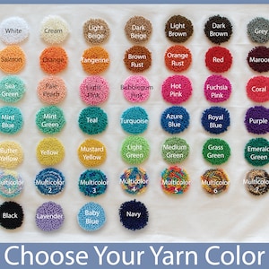 May include: A color chart of yarn samples, showing a variety of colors, including white, cream, beige, brown, orange, red, pink, green, blue, yellow, purple, black, lavender, and baby blue. The chart is labeled "Choose Your Yarn Color".