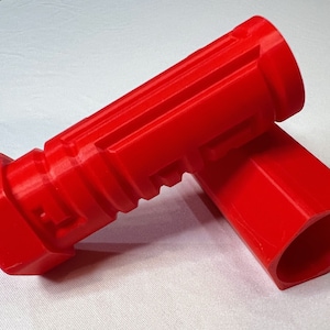 May include: Two red plastic tubes with a hexagonal shape at one end. The tubes are designed to fit together.