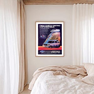 May include: A framed vintage advertisement for the Chevy Astro convertible van. The ad features a series of colourful van illustrations, with the text "NEW CHEVY ASTRO CONVERTIBLE" at the top and "NOTHING WORKS LIKE A CHEVY VAN" at the bottom.
