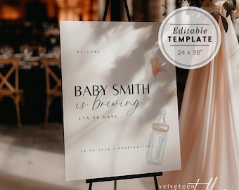 May include: A white welcome sign with black text that reads "Baby Smith is Brewing ETA 58 Days... 20.08.2024 #babysmith24". The sign is on a black easel and has a watercolor illustration of a baby bottle and a bottle of wine.