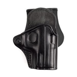 Könnte beinhalten: Ein schwarzes Lederholster mit geformtem Design. Das Holster hat eine Gürtelschlaufe und ist für eine Handfeuerwaffe konzipiert. Das Leder ist glatt und glänzend, mit sichtbaren Nähten an den Kanten.
