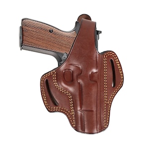 Könnte beinhalten: Ein braunes Lederholster mit einem genähten Design und einer Pistole darin.