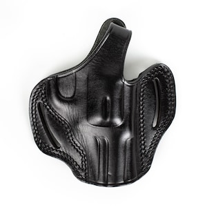 May include: A black leather holster, designed to hold a handgun. It has a moulded shape and detailed stitching around the edges. The holster includes a belt loop and is designed for practicality.