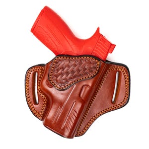 May include: A white ceramic mug with a black handle and the text "But First, Coffee" in a black, handwritten-style font. The mug is on a white surface.