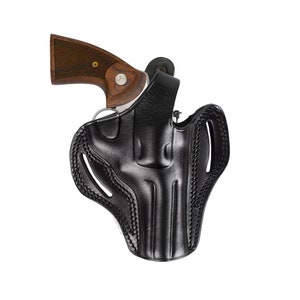 May include: A black leather holster with a stitched design for a revolver. The holster has a belt loop and a trigger guard.