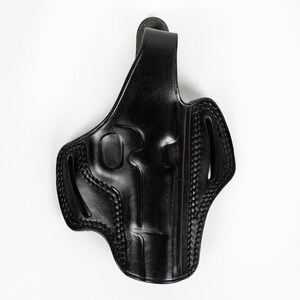 May include: Black leather holster for a handgun. The holster has a belt loop and a thumb break.