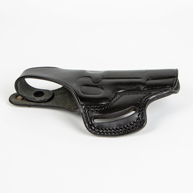 May include: A black leather holster for a handgun. The holster has a belt loop and a snap closure.