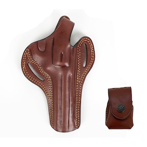 May include: A brown leather holster with a stitched design and a matching brown leather magazine pouch.