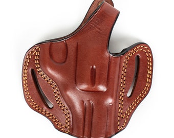 May include: A brown leather holster with a stitched design and a belt loop.